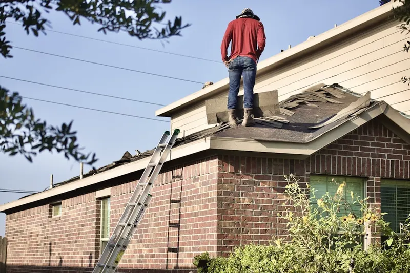 Professional roofer working on a residential roof in Polo Golf And Country Club